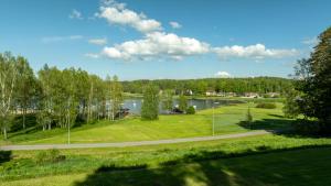 a view of a park with a lake and a road at Reisikoda OÜ in Põlva
