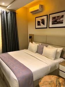 a bedroom with a large white bed in a room at Ringruby Hotel, Oduduwa Way in Ikeja