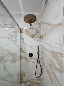 a shower with white marble walls and a ceiling at Estoril House in Estoril +30 photos