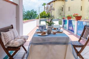 a table and chairs on the balcony of a house at Hotel Ristorante Cavaliere in Scario
