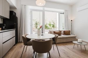 a living room with a table and a couch at Gran Turia Apartments in Valencia