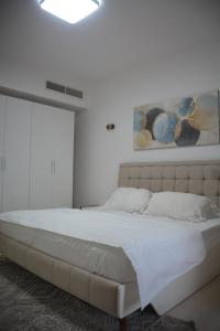 a bedroom with a large bed in a room at Segal Hawana Salalah 2 Bedroom Marina in Salalah +13 photos