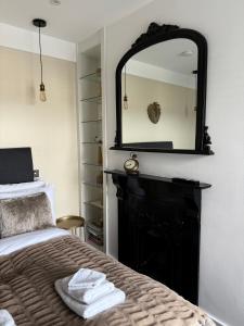 a bedroom with a bed with a mirror on the wall at Luxury double bedroom en suite in London