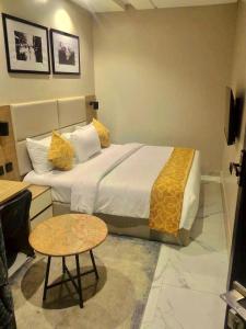 a hotel room with a bed and a table at Ringruby Hotel, Oduduwa Way in Ikeja