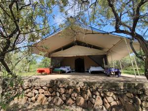 a large tent in the middle of a forest at Mattikoko Safari Camp in Aitong