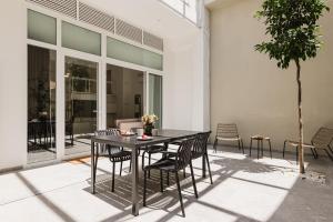 a patio with a black table and chairs at Gran Turia Apartments in Valencia +115 photos