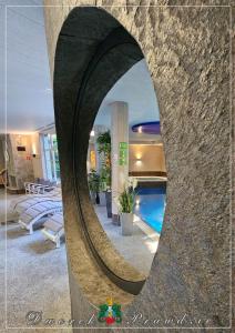 a swimming pool in a building with a mirror at Dworek Prawdzic Niechorze in Niechorze +102 photos