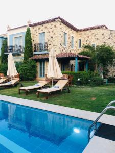 a villa with a swimming pool in front of a house at On Oda Alaçatı in Alaçatı +40 photos