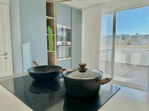 a kitchen with a bowl and a bowl on a glass table at Duplex Penthouse Prime Location in St Julian's