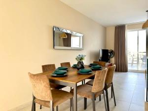 a dining room with a wooden table and chairs at Duplex Penthouse Prime Location in St Julian's +23 photos