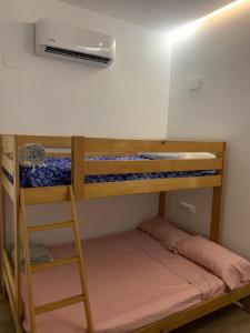 a room with two bunk beds and a heater at Apartamento El Atardecer in El Perelló