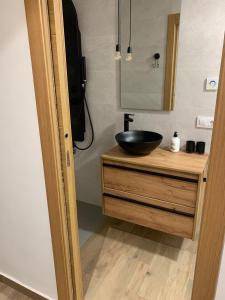a bathroom with a black bowl sink on a wooden counter at Apartamento El Atardecer in El Perelló