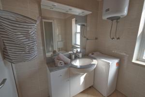 a bathroom with a sink and a mirror at Apartment Poli šterne, two rooms and pet friendly in Rakalj +37 photos