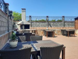 a patio with a table and chairs and a fireplace at Family hotel Delfa in Chernomorets