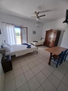 a bedroom with a bed and a table in it at Agnanti Kotsikia in Kotsikiá