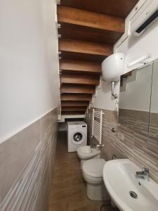 a bathroom with a toilet and a sink at Casa Helvius - Dimora in centro storico in Sant'Egidio del Monte Albino