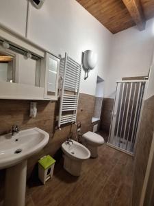 a bathroom with a sink and a toilet at Casa Helvius - Dimora in centro storico in Sant'Egidio del Monte Albino