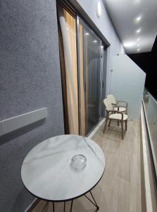 a white table in a room with a window at Mario's rooms in Himare