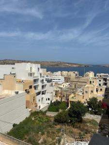 a city with white buildings and a body of water at Flavia and Angelo's house in St. Paul's Bay +5 photos