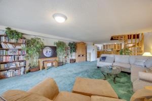 a living room with a couch and a table at 3 Mi to Garden of the Gods Quiet Home with Hot Tub! in Colorado Springs
