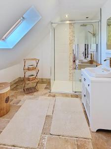 a bathroom with a glass shower and a sink at Kerinou in Guimaëc