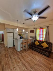 a living room with a couch and a ceiling fan at Amazon Villas in Soufrière