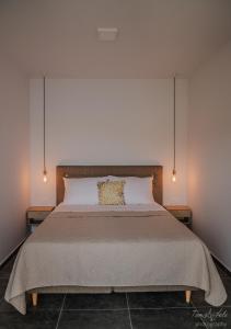 a bedroom with a large bed with two lamps at Modern two bedroom seafront oasis in Skrivena Luka