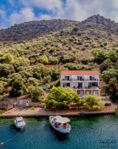an aerial view of a house with two boats in the water at Modern two bedroom seafront oasis in Skrivena Luka