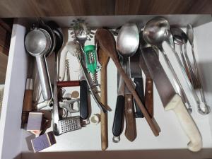 a drawer filled with lots of kitchen utensils at Casa perto da Uopecan in Cascavel