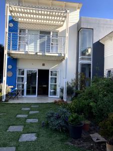 a house with a balcony and a patio at Waterfront Stay Holiday Home in Swakopmund