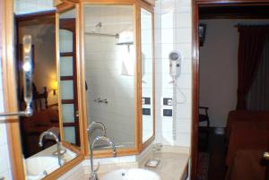 a bathroom with a mirror and a sink at Hotel El Relicario Del Carmen in Quito +92 photos
