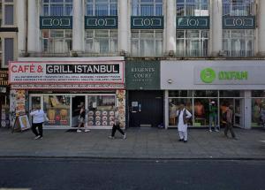 a group of people walking in front of a building at 3BR, smart TV, self check-in, coffee machine in Manchester