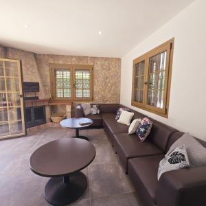 a living room with a couch and a table at Costabravasuites villa can duk in Caldes de Malavella