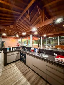 a large kitchen with a large counter top at Puxadinho São Pedro in São Pedro