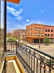 a balcony with a view of a street and buildings at Marakech home in Marrakesh