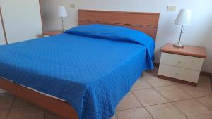 En eller flere senge i et værelse på Appartamento Spiaggia