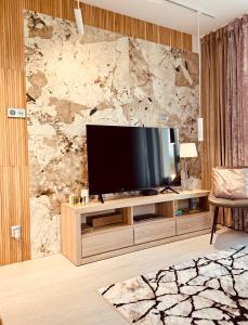 a living room with a flat screen tv on a entertainment center at Sweet Dreams Apart in Szczytno