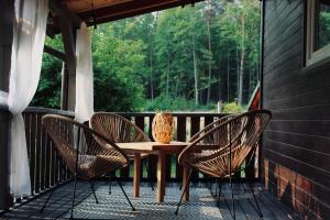 a wooden table and chairs on a porch at Domek U Stefanów - Królowy Most in Królowy Most
