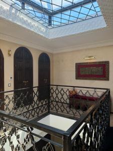 a balcony with a black railing and two doors at Riad M'Barka in Tangier