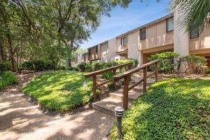 a building with a staircase in front of a building at 2098 Beach Wood in Amelia Island