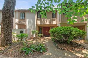 a house with a tree in front of it at 2098 Beach Wood in Amelia Island