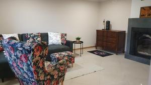 a living room with a couch and a fireplace at Apartamenty Marii Kawik in Brenna
