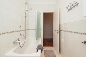a bathroom with a shower and a bath tub at Spinut Urban Retreat in Split +10 photos