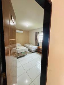 Postel nebo postele na pokoji v ubytování Casa Temporada Suítes