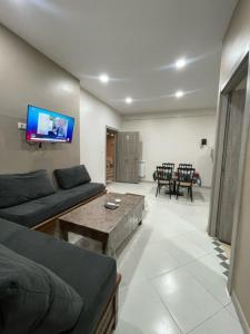a living room with a couch and a table at Appart - Hotel AS in Aïn El Turk