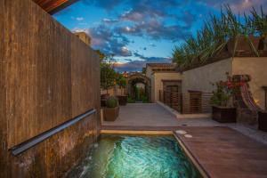 a swimming pool in the middle of a house at Casa No Name Small Luxury Hotel in San Miguel de Allende