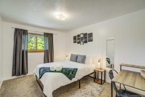a bedroom with a bed and a window at Alder Nest Cozy Retreat w Fire Pit & Workspace in Colorado Springs