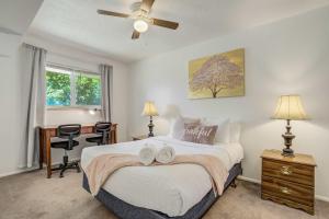 a bedroom with a bed with two towels on it at Alder Row Private Patio w Fire Pit & Workspaces in Colorado Springs