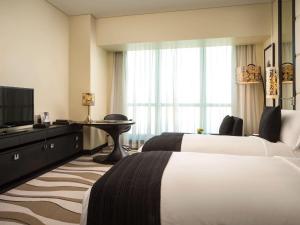 Cama o camas de una habitación en Sofitel Abu Dhabi Corniche