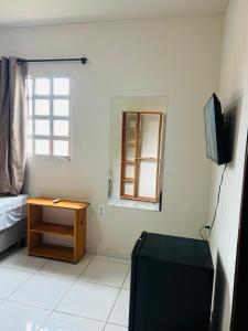 TV a/nebo společenská místnost v ubytování Casa Temporada Suítes